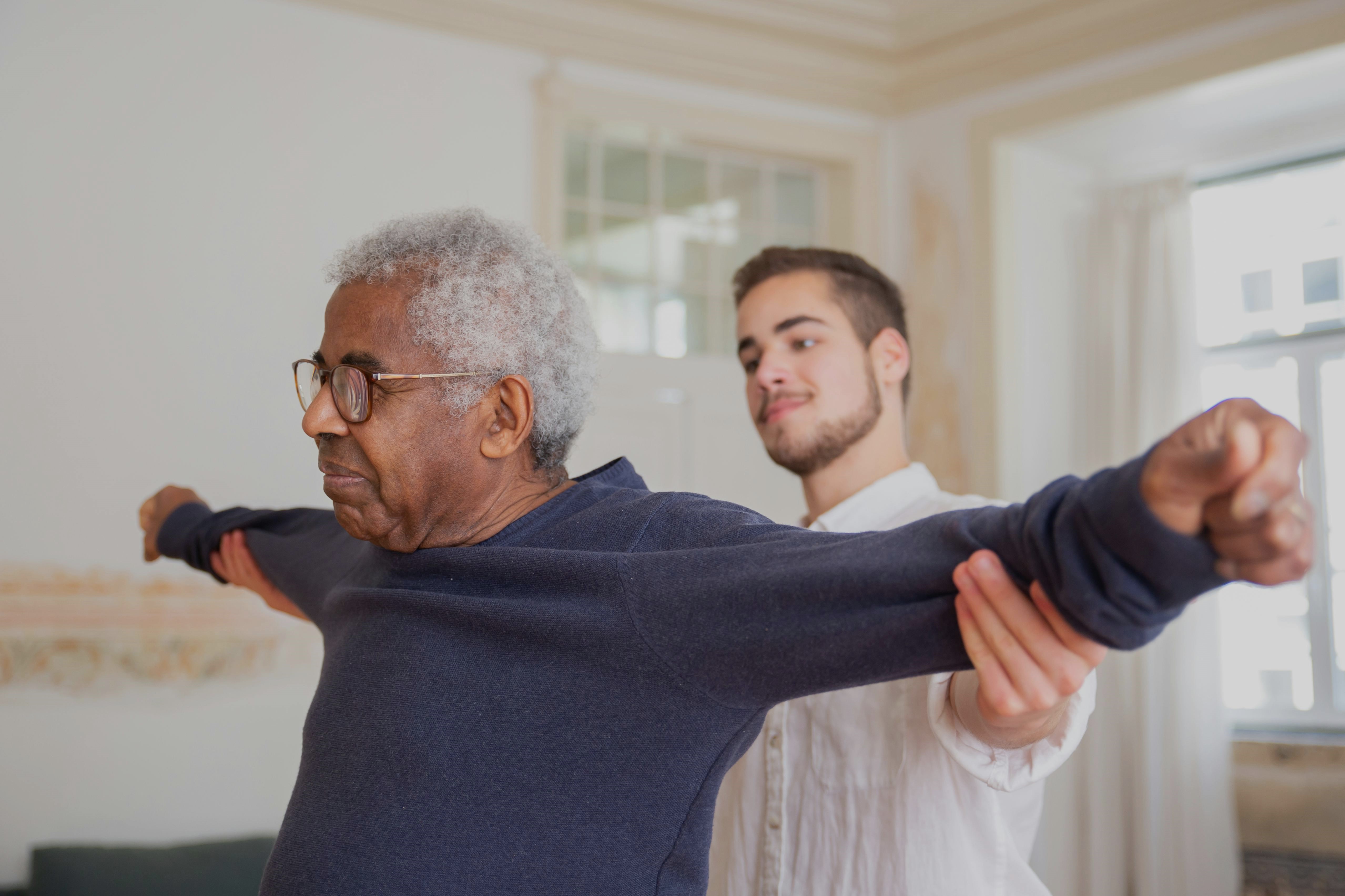 Nurse helping patient to stretch